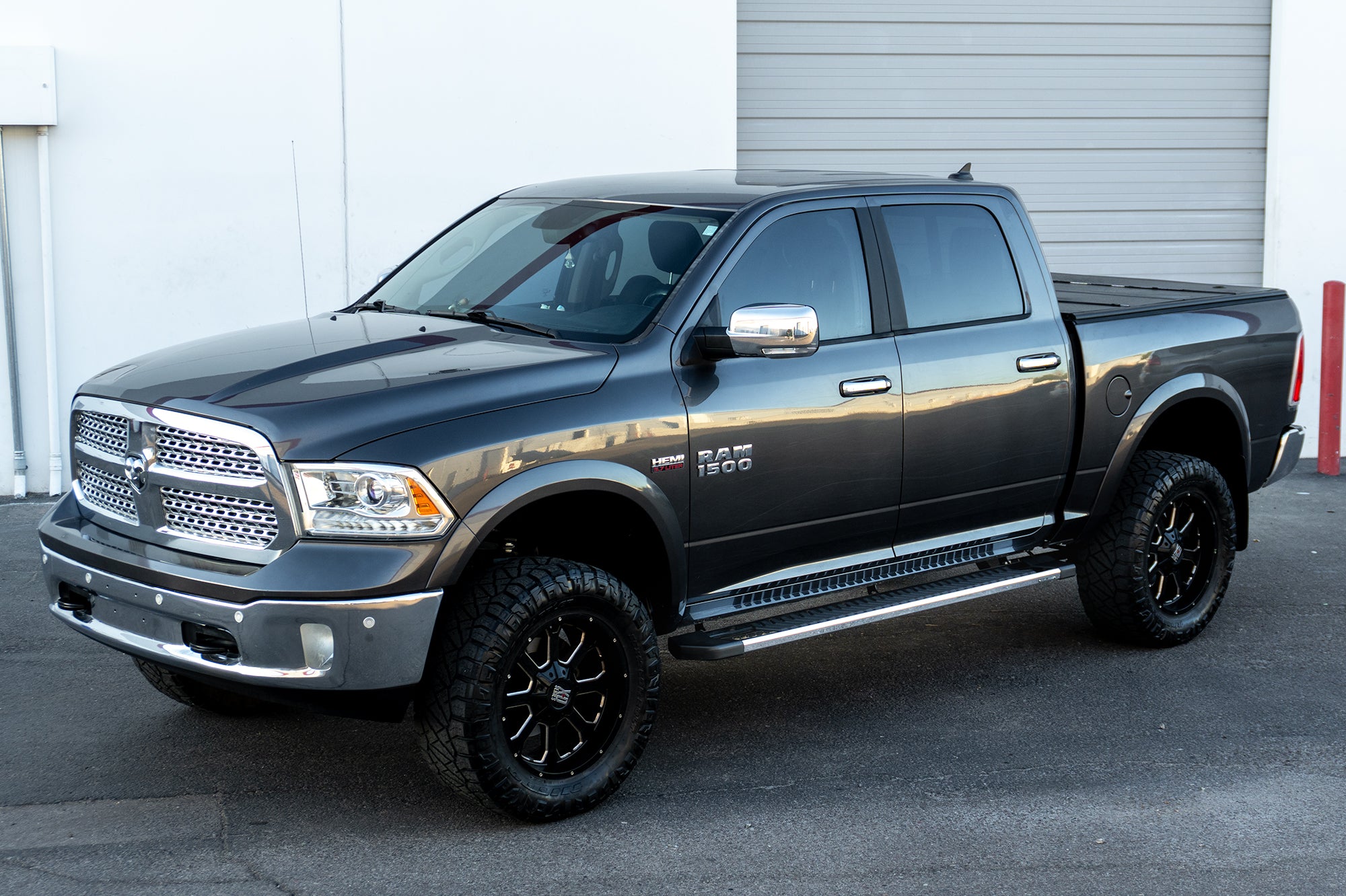 An image of a grey RAM 1500 with CYC Engineering's OEM style full tread running boards installed. 