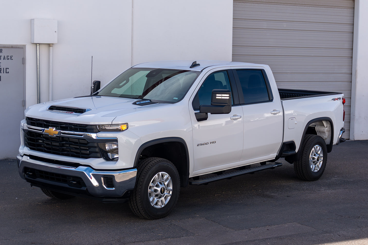 CYC Engineering's 5 inch OEM Style Full Tread Slide Track Running Boards in Black Textured Aluminum on a blue Chevrolet truck.
