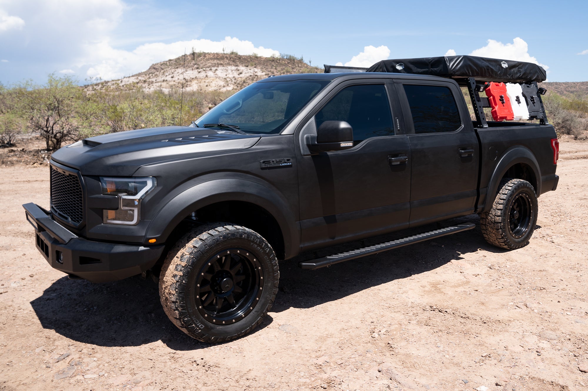 CYC Engineering's 5 inch OEM Style Full Tread Slide Track Running Boards in Black Textured Aluminum on a black Ford truck.