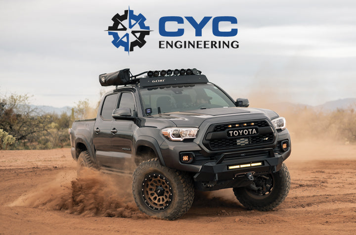 An image of a Toyota truck offroading in the sand with the CYC Engineering logo overlayed at the top of the image.